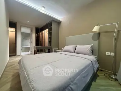 Modern bedroom with cozy bed and built-in closet in stylish apartment
