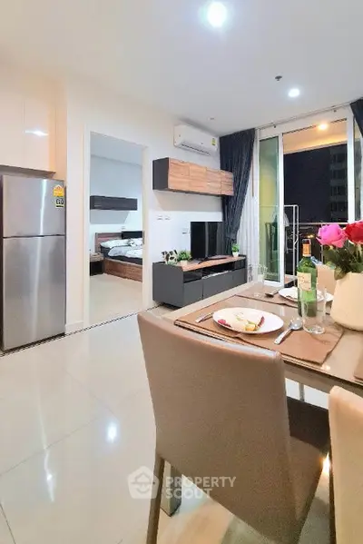 Modern open-plan living room with dining area and balcony view