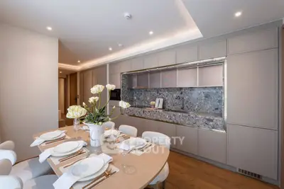 Luxurious modern kitchen with elegant dining area and sleek cabinetry
