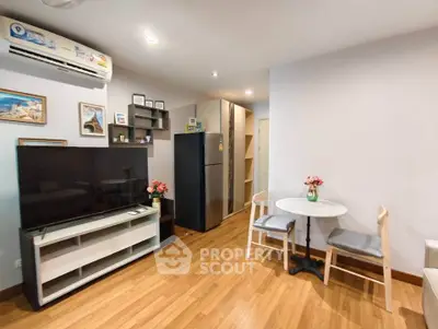Modern living room with wooden flooring, stylish furniture, and a cozy dining area in a contemporary apartment.