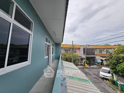 Charming residential balcony with street view and modern exterior design.