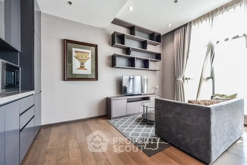 Modern living room with sleek furniture and large windows in a stylish apartment.