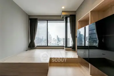 Modern living room with city view, featuring sleek wooden flooring and large windows.