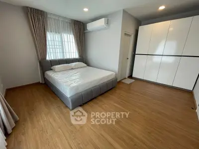 Spacious bedroom with modern design and ample natural light