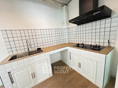Modern kitchen with gas stove and sleek white cabinetry