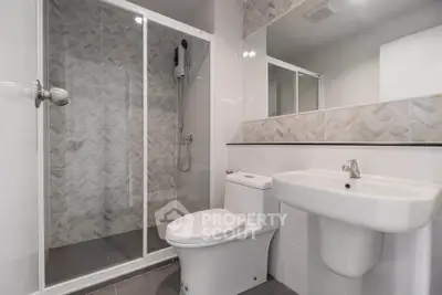 Modern bathroom with sleek shower and elegant fixtures in a contemporary home.