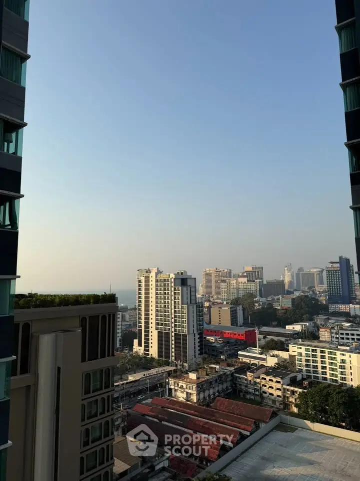 Stunning cityscape view from high-rise building balcony at sunrise.