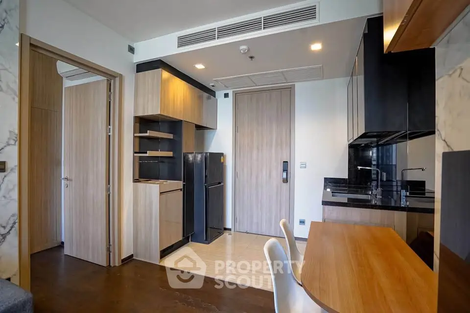 Modern kitchen with sleek cabinetry and integrated appliances in a stylish apartment.
