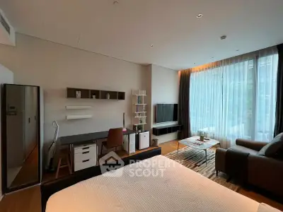 Modern studio apartment with stylish decor, featuring a cozy bed, sleek desk, and comfortable seating area.