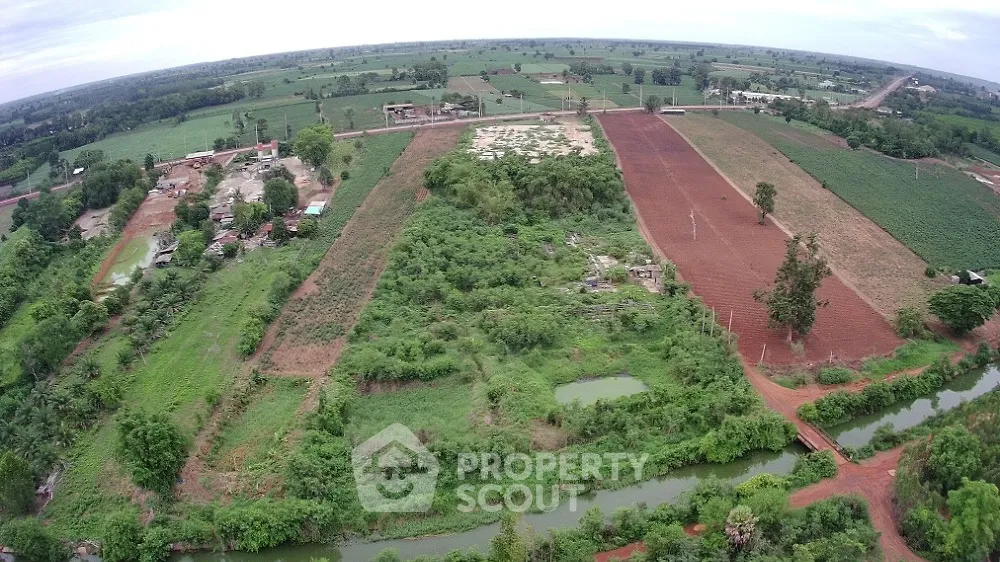 Expansive aerial view of lush farmland with diverse crops and scenic landscape