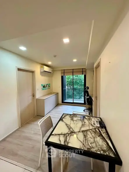 Modern apartment interior with marble table and balcony view, perfect for urban living.