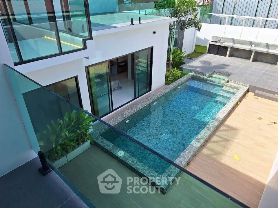 Modern luxury home with private pool and glass balcony, perfect for relaxation and entertainment.
