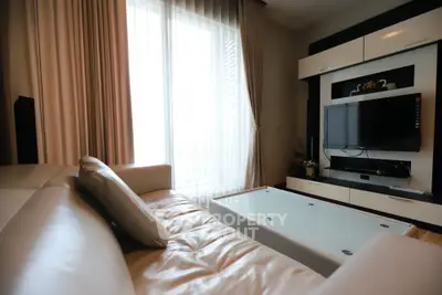 Modern living room with sleek furniture and large window for natural light.