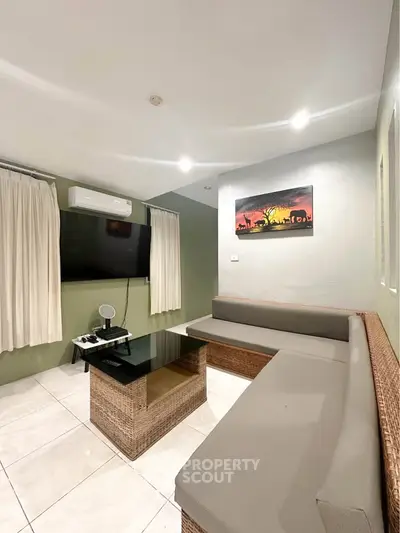 Cozy living room with modern decor and wall-mounted TV