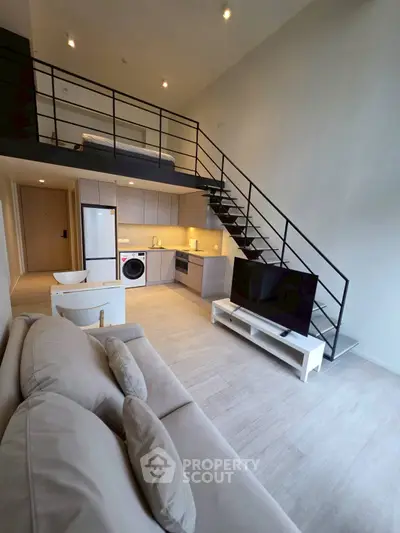 Modern loft apartment with open kitchen and stylish staircase