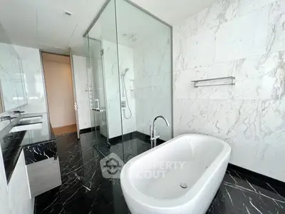 Luxurious modern bathroom with freestanding bathtub and glass shower enclosure