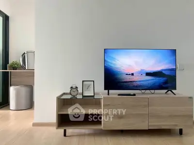 Modern living room with sleek TV setup and stylish wooden furniture