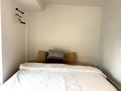Cozy bedroom with modern decor and comfortable bedding, perfect for relaxation and rest.