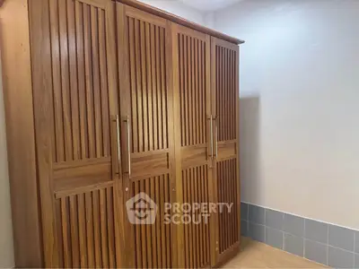 Spacious wooden wardrobe in a modern interior, perfect for ample storage solutions.