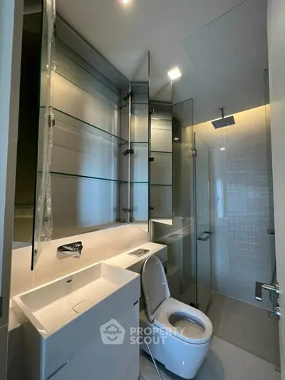 Modern bathroom with sleek fixtures and glass shower enclosure