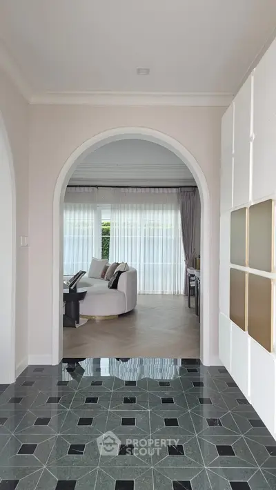 Elegant living room with arched entry and stylish furniture