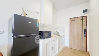 Modern kitchen with sleek appliances and minimalist design in a bright apartment.
