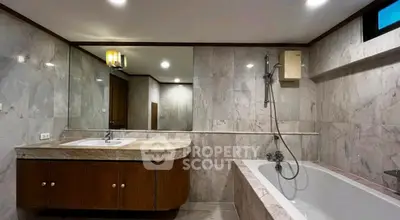 Luxurious marble bathroom with bathtub and elegant lighting