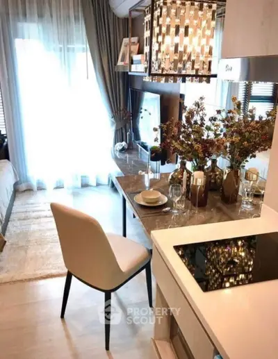 Modern open-plan kitchen and dining area with elegant decor and natural light.