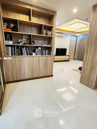 Spacious modern living room with elegant wooden shelving and sleek flooring