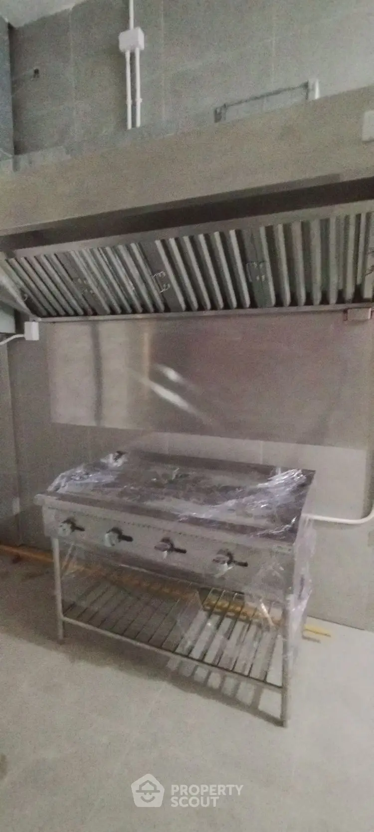 Commercial kitchen with industrial stove and ventilation system