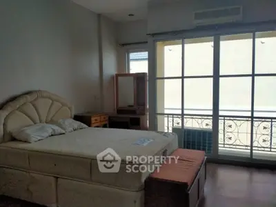 Cozy bedroom with large window and elegant bed, perfect for relaxation and comfort.