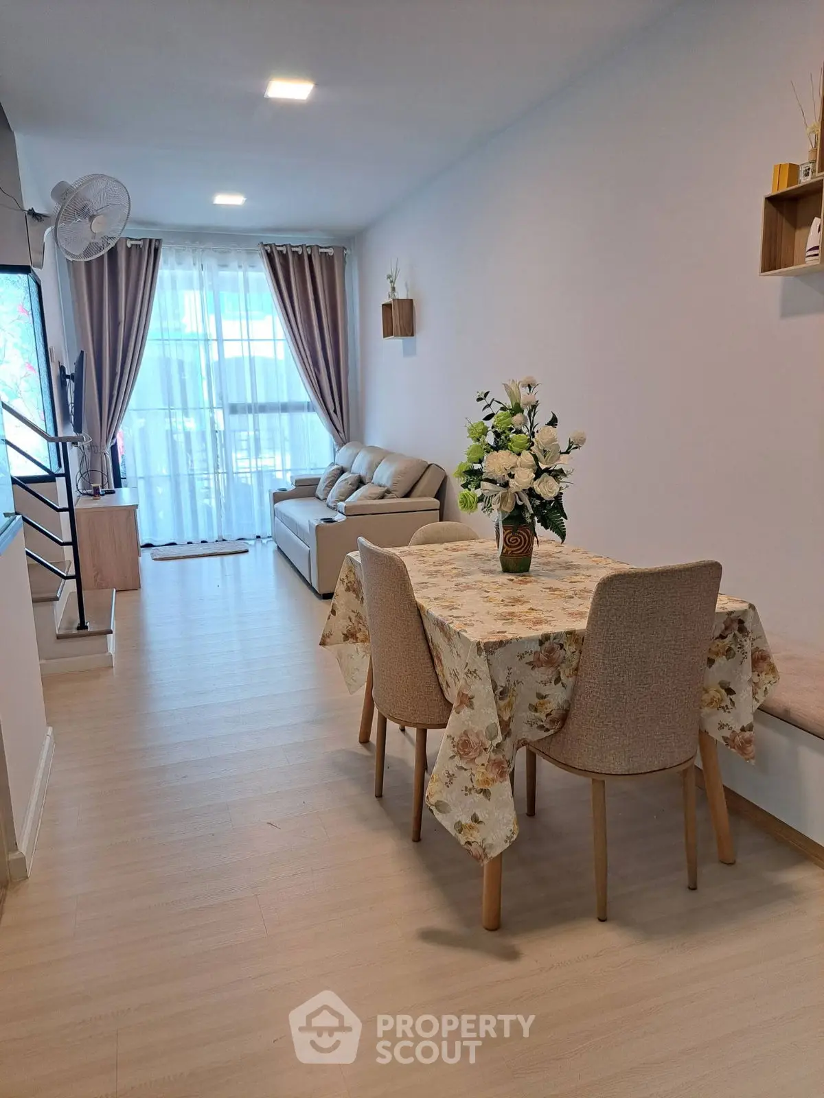 Charming living room with elegant decor and natural light, perfect for relaxation and entertaining.