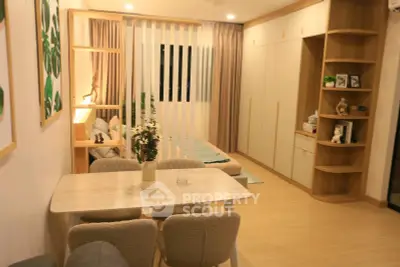Modern open-plan living room with dining area and cozy bedroom in stylish apartment.