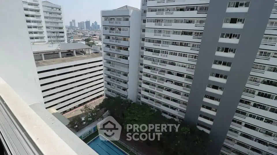 High-rise residential buildings with a swimming pool view in an urban setting.