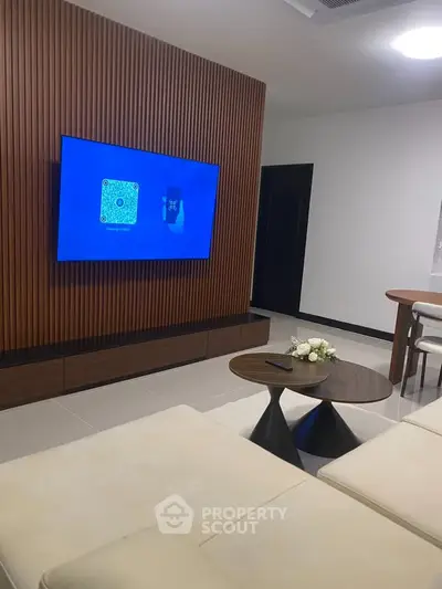Modern living room with sleek TV setup and stylish furniture, perfect for contemporary living.