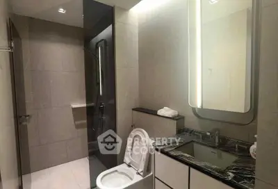 Modern bathroom with sleek design and elegant fixtures, featuring a spacious shower and stylish vanity.