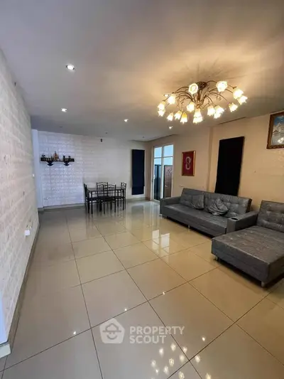 Spacious living room with modern chandelier and elegant dining area