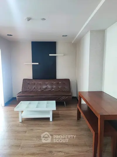 Modern living room with wooden flooring and minimalist furniture