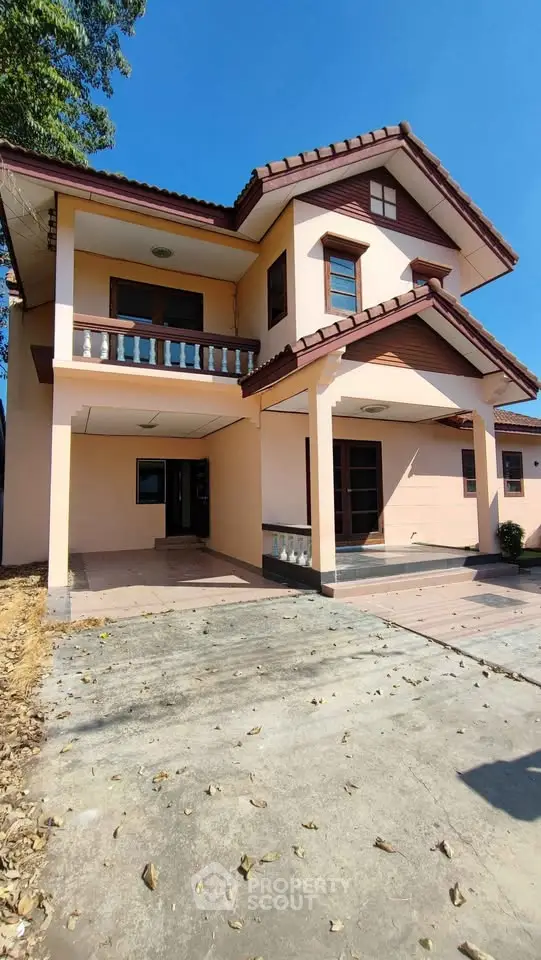 Charming two-story house with spacious driveway and classic architectural design.