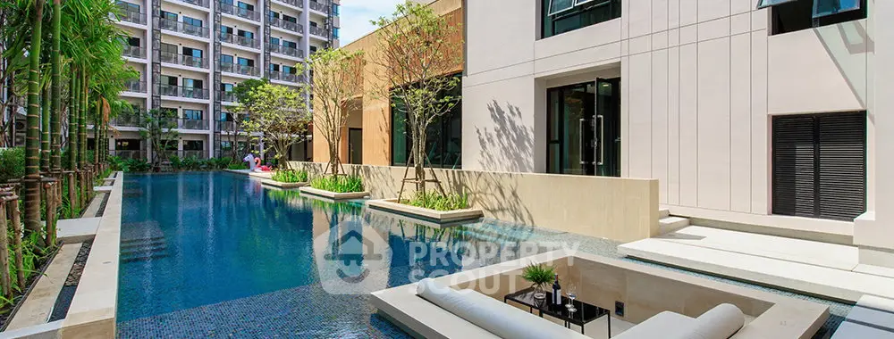 Luxurious apartment complex with stunning pool and modern architecture, perfect for upscale living.
