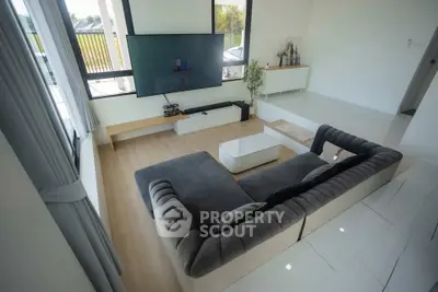 Spacious modern living room with large windows and stylish furniture