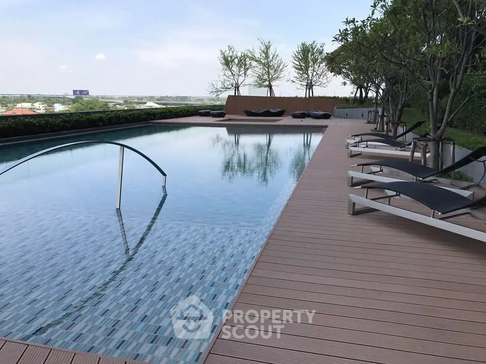 Luxurious rooftop pool with sun loungers and scenic views, perfect for relaxation and leisure.