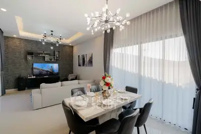 Elegant modern living room with stylish dining area and large windows