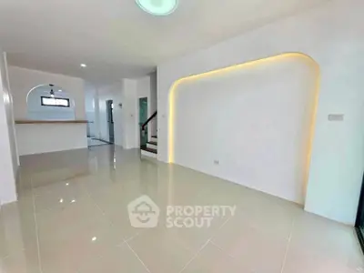 Spacious modern living room with sleek tile flooring and ambient lighting