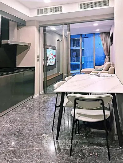 Modern open-layout kitchen and living room with sleek design and marble flooring.