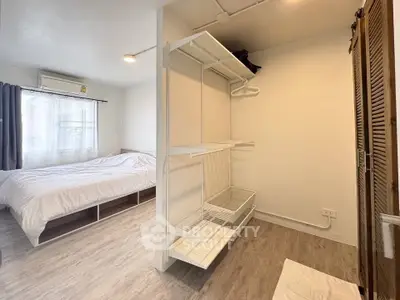 Spacious bedroom with modern open closet and natural light