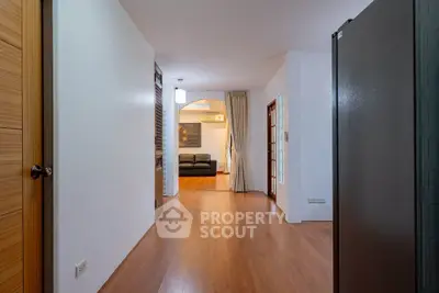 Spacious open layout with wooden flooring and modern decor in a cozy living area.