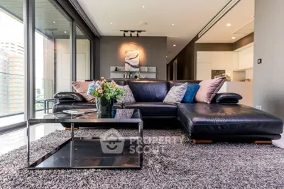 Luxurious living room with plush seating and modern decor, featuring floor-to-ceiling windows and elegant lighting.