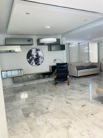 Spacious modern living room with marble flooring and stylish furniture