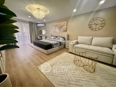 Luxurious bedroom with elegant decor and spacious layout, featuring a cozy seating area and modern lighting.